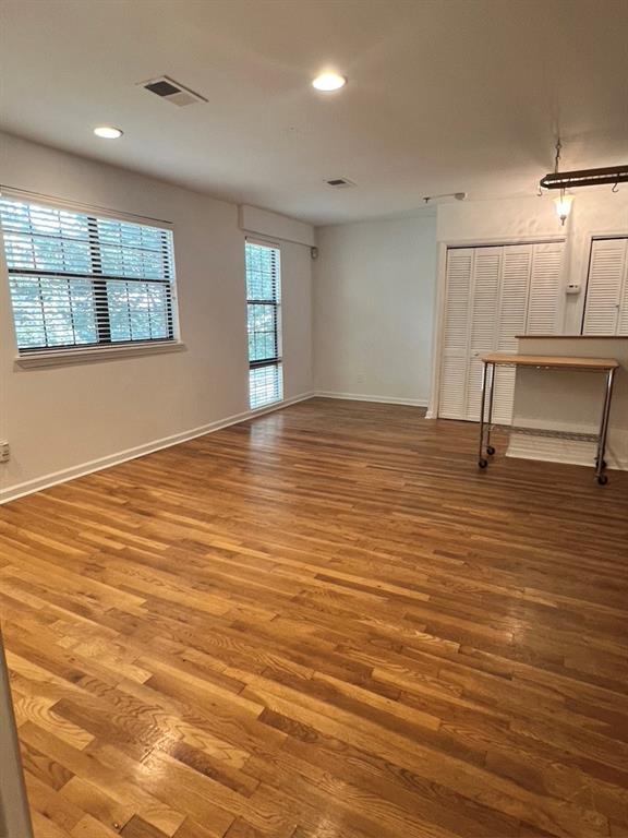323 8th Street Northeast, Unit 6 Atlanta, GA 30309 - Photo 7 of 15 a view of an empty room with window and wooden floor