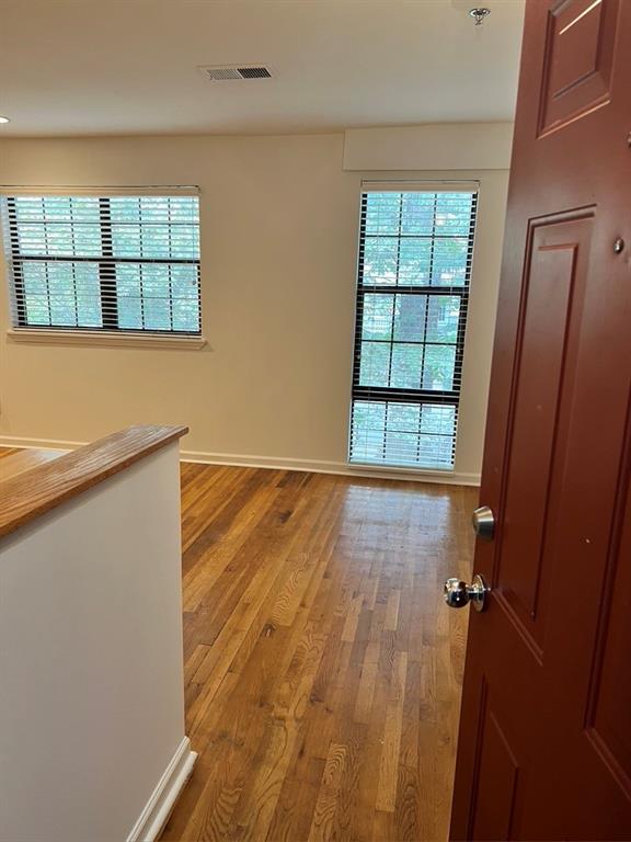 323 8th Street Northeast, Unit 6 Atlanta, GA 30309 - Photo 8 of 15 wooden floor in an empty room with a window