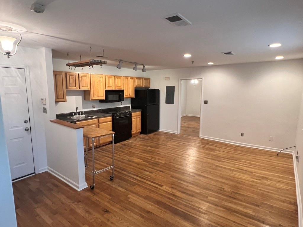 323 8th Street Northeast, Unit 6 Atlanta, GA 30309 - Photo 9 of 15 a kitchen with stainless steel appliances granite countertop a refrigerator and a stove top oven