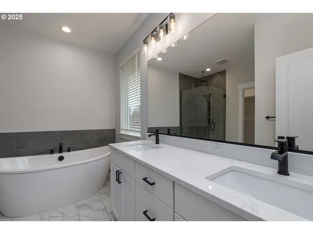 a bathroom with a bathtub and a shower