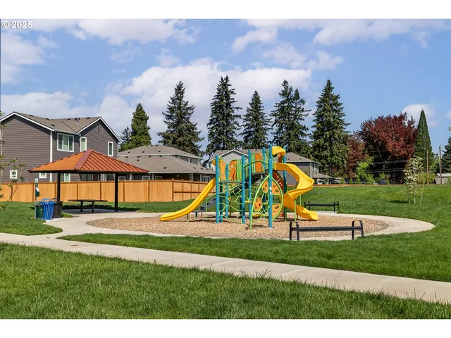 a view of a park with swings and slides