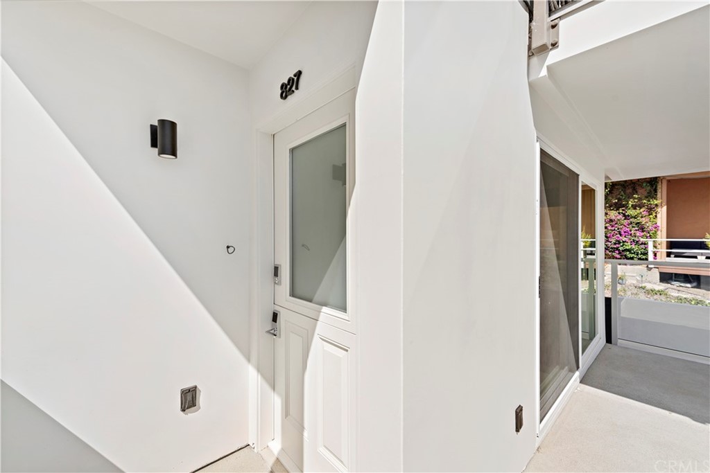 827 Cliff Drive Laguna Beach, CA 92651 - Photo 15 of 19 a view of a hallway with white walls and stairs
