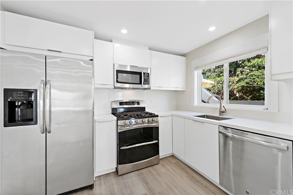 827 Cliff Drive Laguna Beach, CA 92651 - Photo 9 of 19 a kitchen with stainless steel appliances a stove a sink and a refrigerator