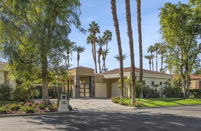 a view of a apartment building next to a yard