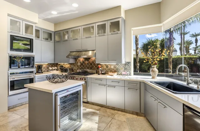 a kitchen with a sink stove and cabinets