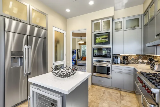 a kitchen with stainless steel appliances a stove a sink and a refrigerator