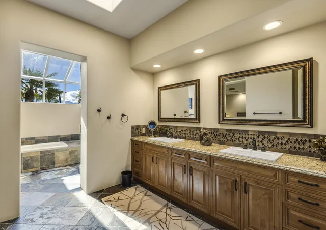 a bathroom with a double vanity sink and a mirror