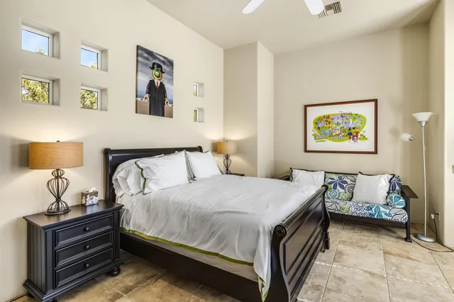 a bedroom with a bed and lamp