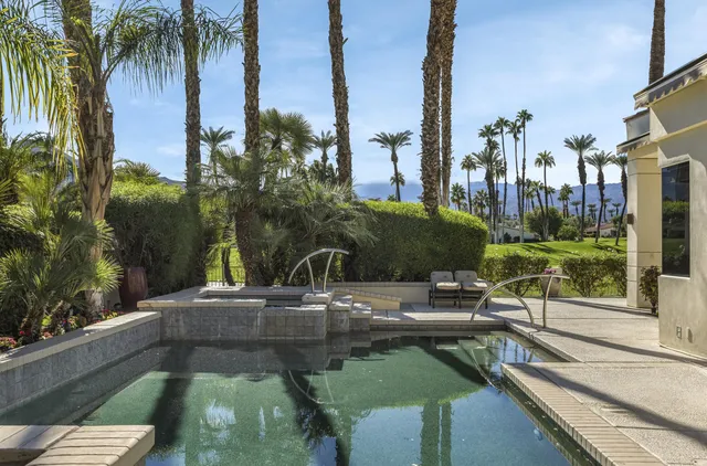 a view of a swimming pool with a patio