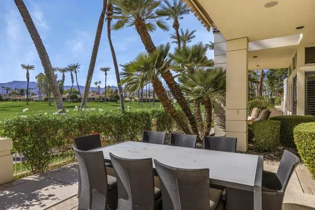a view of a patio with table and chairs and potted plants