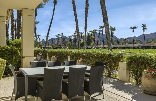 a view of a chairs and table in patio