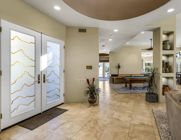 a living room with furniture a dining table and a potted plant