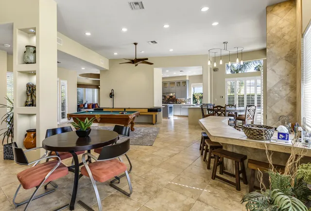 a dining hall with lots of tables and chairs