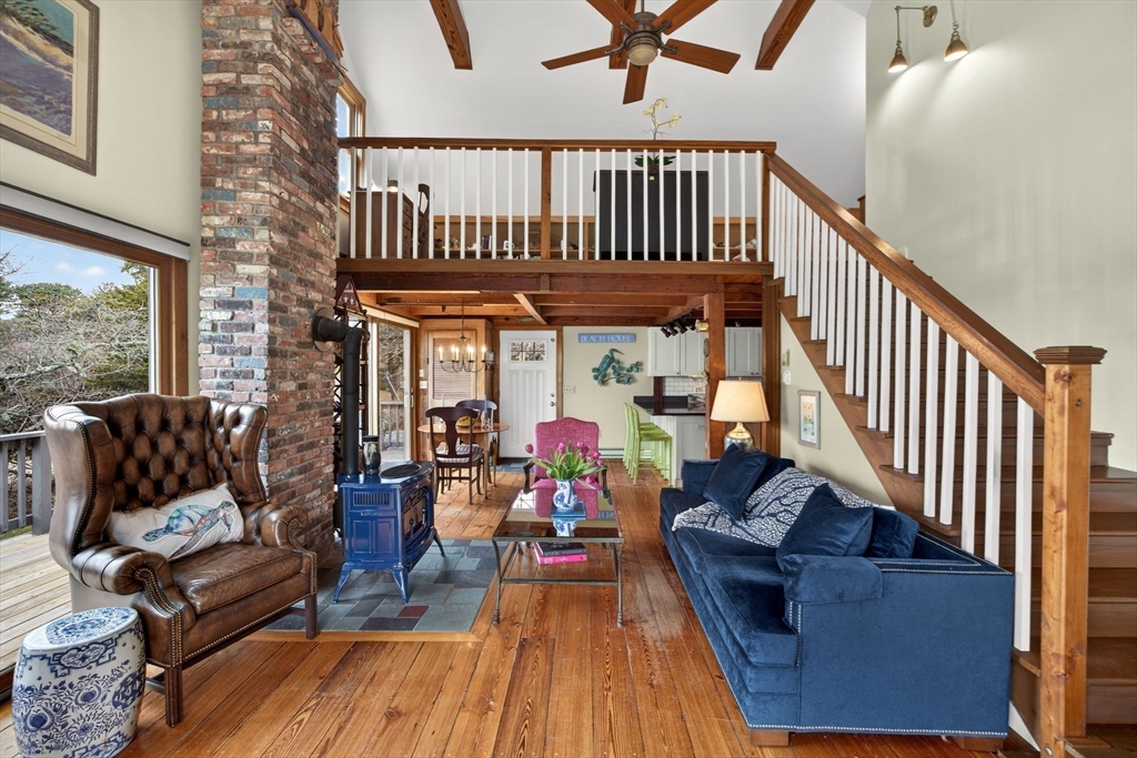 655 Herring Brook Road Eastham, MA 02642 - Photo 11 of 40 a living room with furniture a deck and a dining table