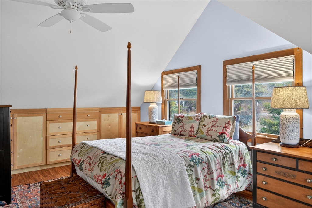655 Herring Brook Road Eastham, MA 02642 - Photo 21 of 40 a bedroom with a large bed and a lamp on table