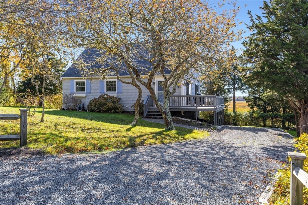 655 Herring Brook Road Eastham, MA 02642 - Photo 4 of 40 a view of a house with swimming pool next to a yard