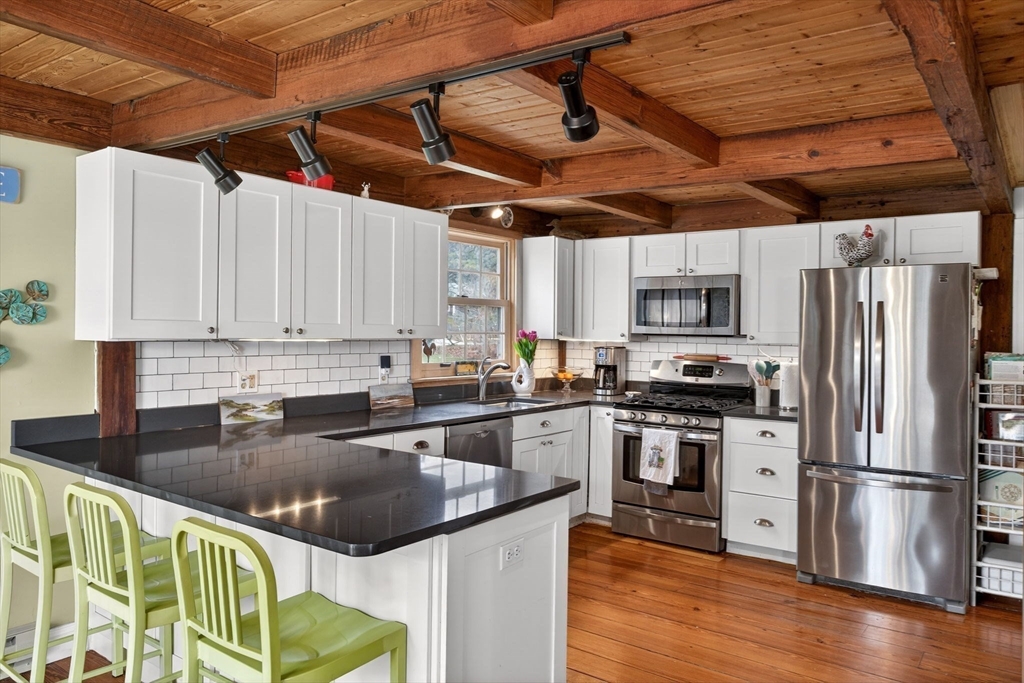 655 Herring Brook Road Eastham, MA 02642 - Photo 7 of 40 a kitchen with stainless steel appliances granite countertop a stove sink and refrigerator