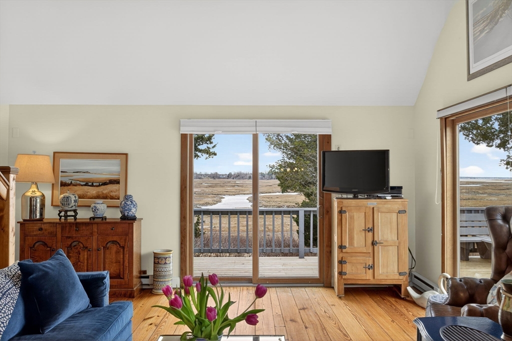 655 Herring Brook Road Eastham, MA 02642 - Photo 9 of 40 a living room with furniture and a flat screen tv