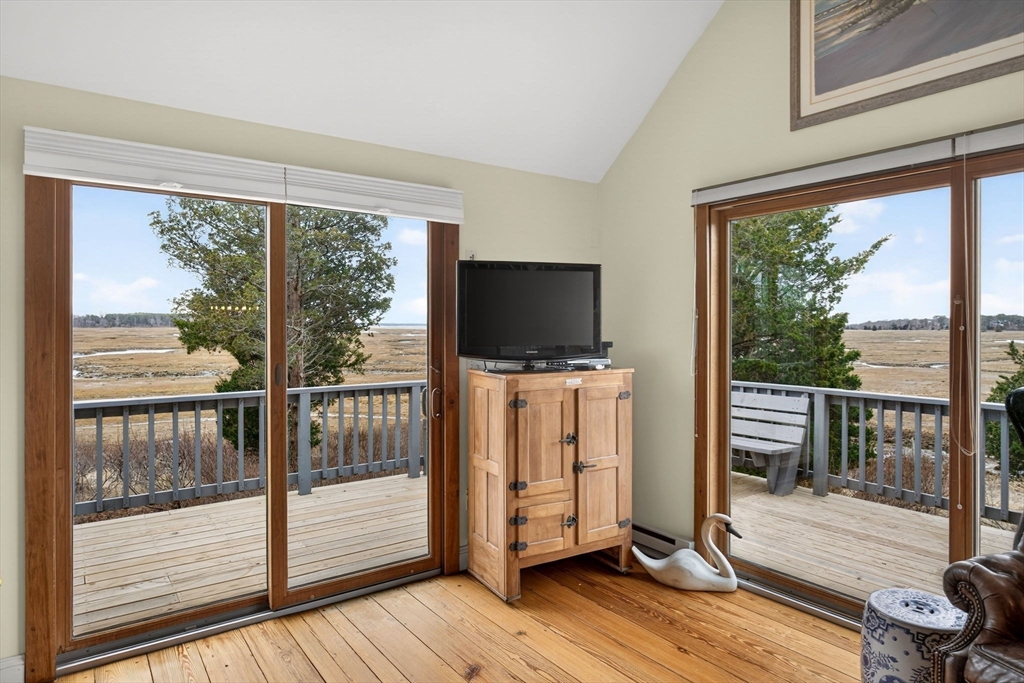 655 Herring Brook Road Eastham, MA 02642 - Photo 10 of 40 a view of a flat screen tv with wooden floor