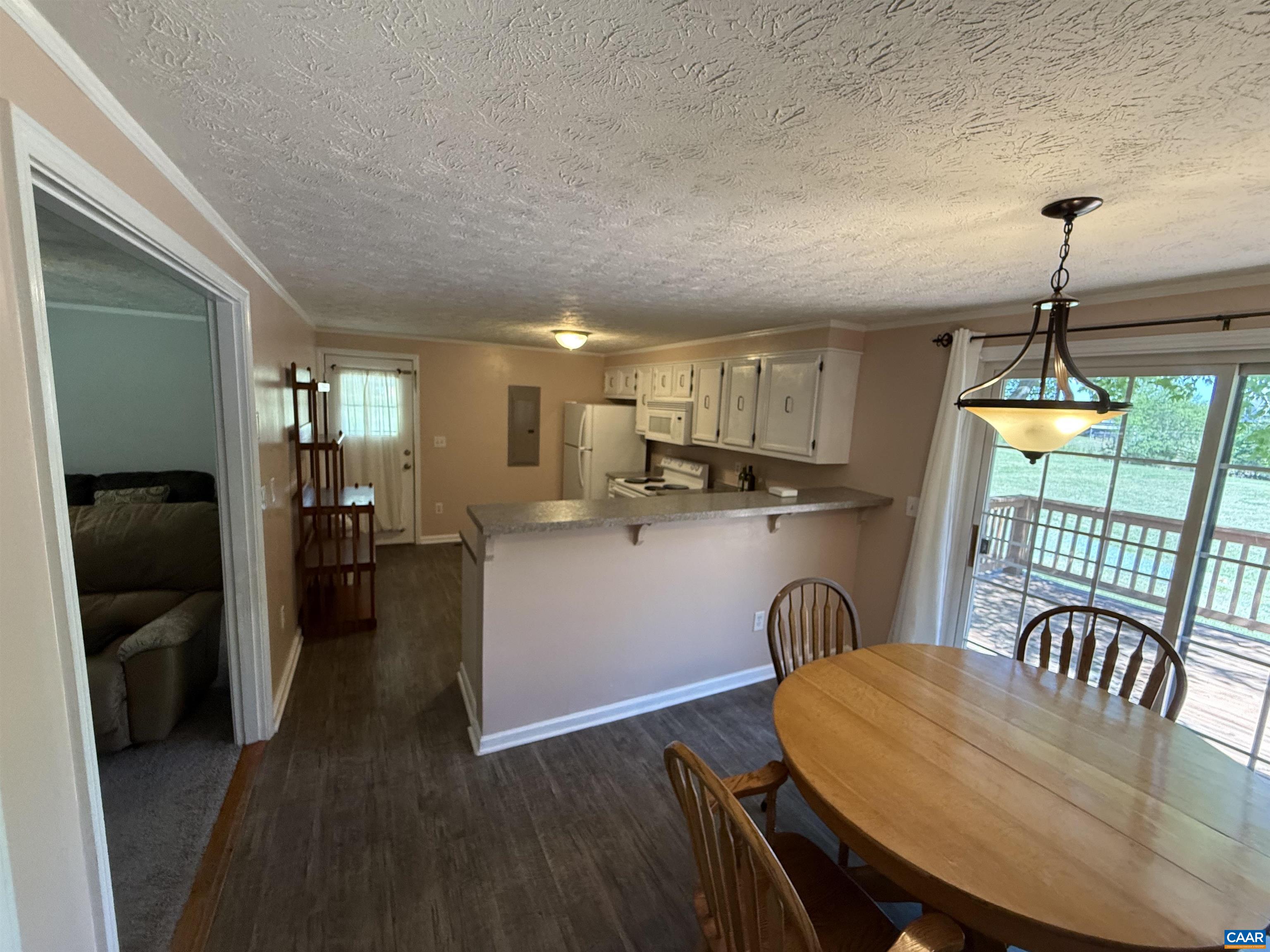 2002 Oliver Creek Road Troy, VA 22974 - Photo 11 of 38 a kitchen with stainless steel appliances granite countertop a stove a refrigerator a kitchen island a dining table and chairs with wooden floor