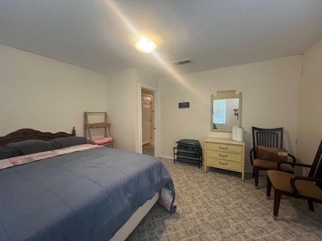 218 Wight Street Roxton, TX 75477 - Photo 13 of 18 a bedroom with a bed and furniture