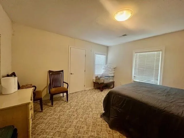a bedroom with a bed and a chair