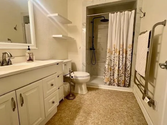 a bathroom with a sink toilet and shower