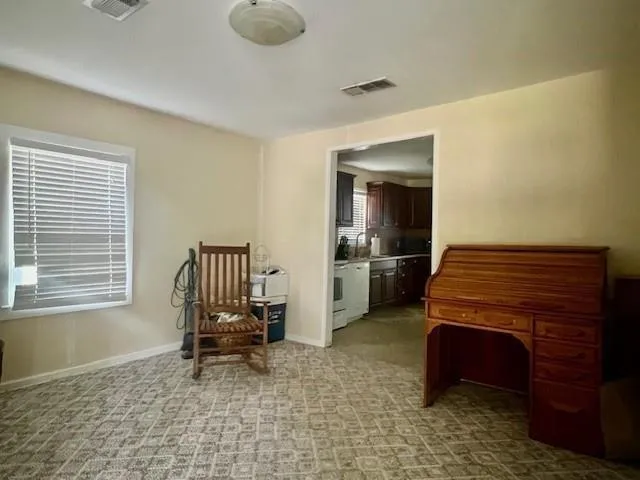a room with a chair and piano table