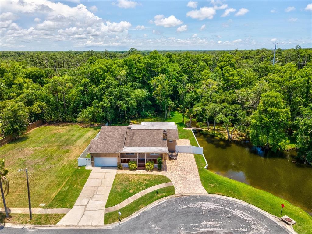 5904 Springrun Court Holiday, FL 34690 - Photo 1 of 53 an aerial view of a house with pool lake view and mountain view