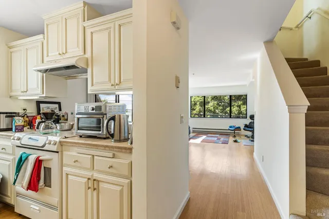 a kitchen with a sink stove and cabinets