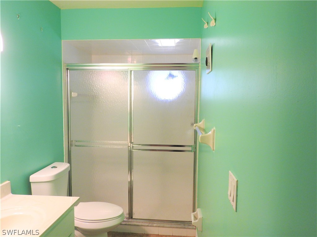 5936 Tarpon Road Bokeelia, FL 33922 - Photo 10 of 17 a bathroom with a toilet and a shower