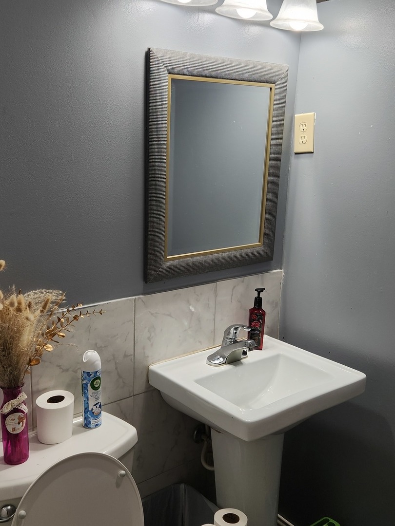 3334 North Harding Avenue Chicago, IL 60618 - Photo 7 of 25 a bathroom with a sink vanity and a mirror