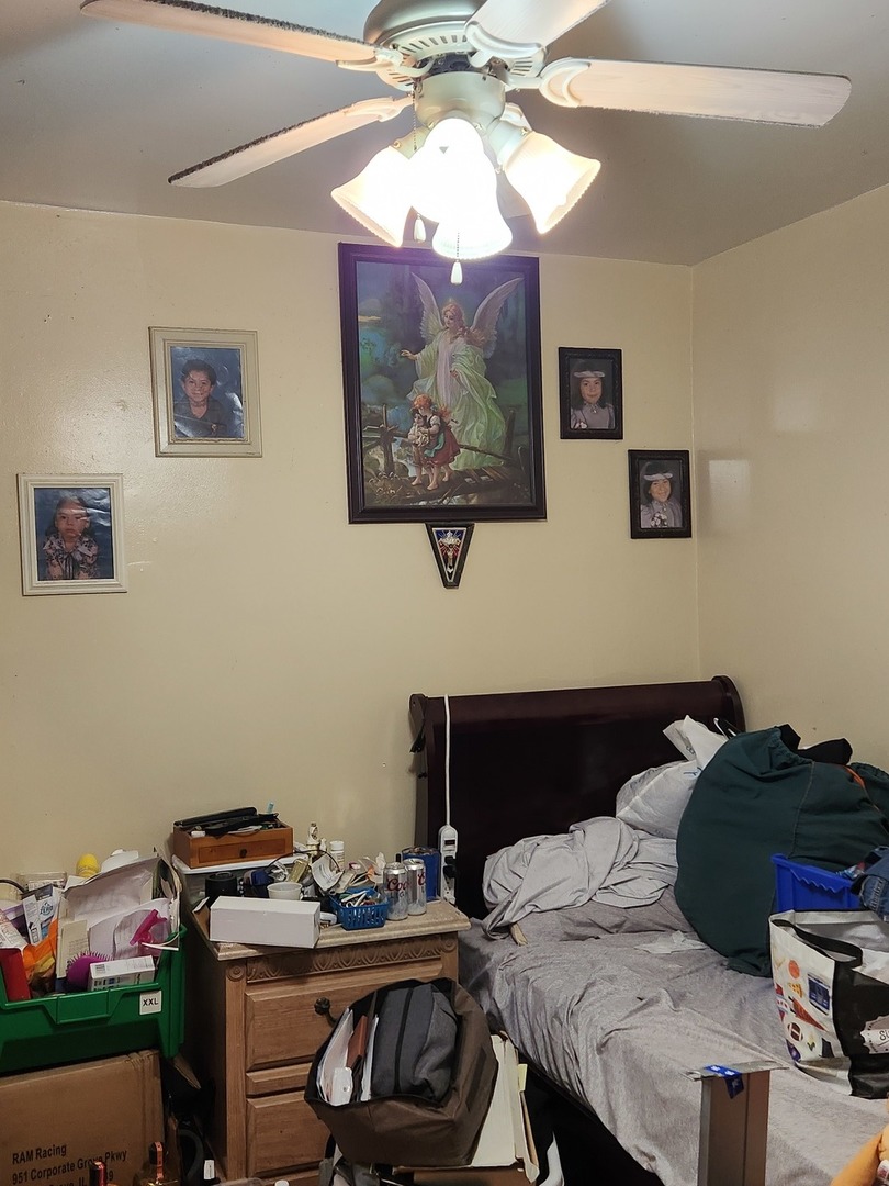 3334 North Harding Avenue Chicago, IL 60618 - Photo 8 of 25 a bedroom with a bed and a chandelier