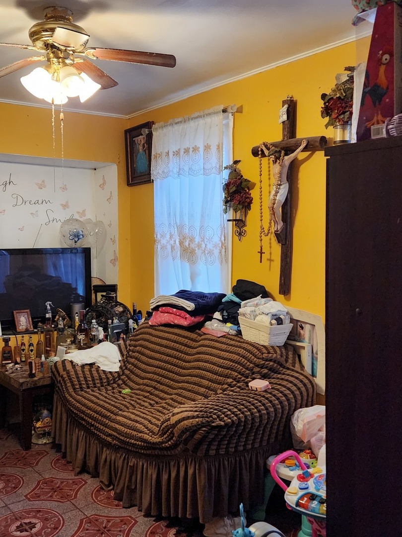 3334 North Harding Avenue Chicago, IL 60618 - Photo 9 of 25 a bedroom with a bed and a chandelier