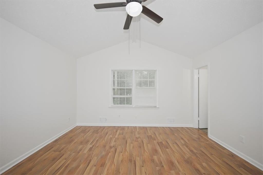 1496 Cherry Hill Road Southwest Conyers, GA 30094 - Photo 15 of 32 a view of empty room with wooden floor and fan