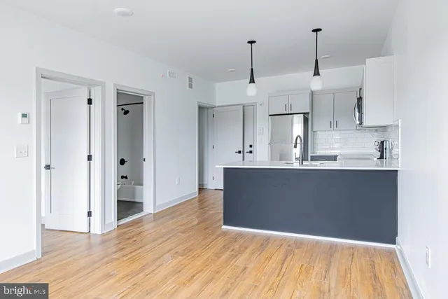 a view of kitchen and kitchen with stainless steel appliances