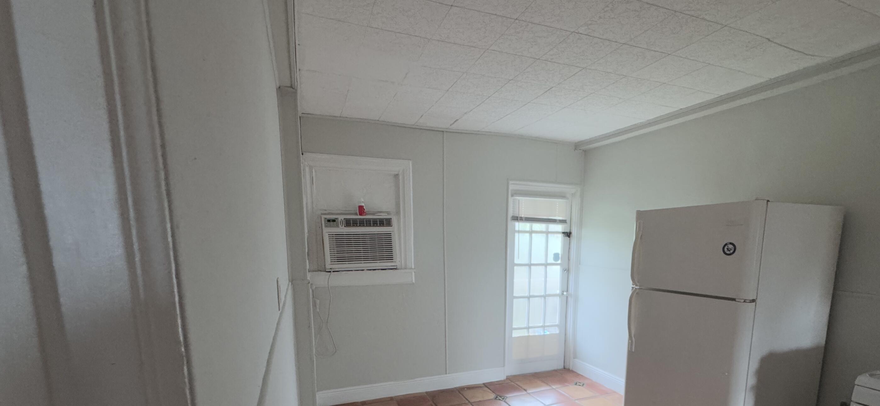 736 Omar Road, Unit 4 West Palm Beach, FL 33405 - Photo 2 of 17 a view of a refrigerator in kitchen and wooden floor