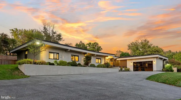 a view of a house with a yard and a garage