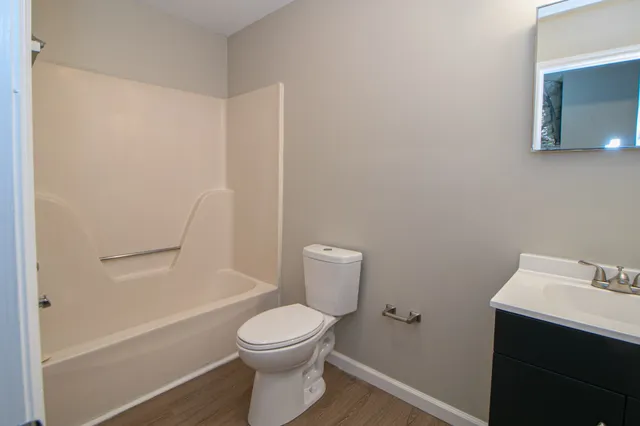 a white toilet sitting next to a bathroom sink