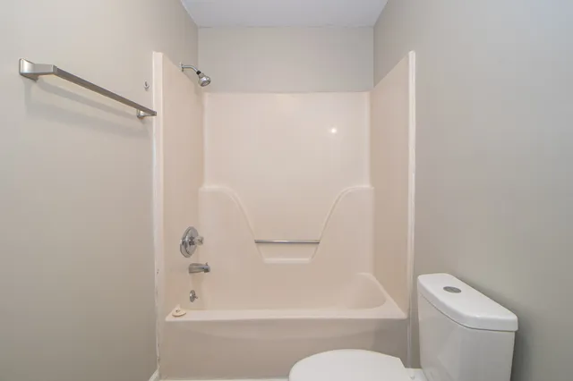 a bathroom with a toilet and a bathtub