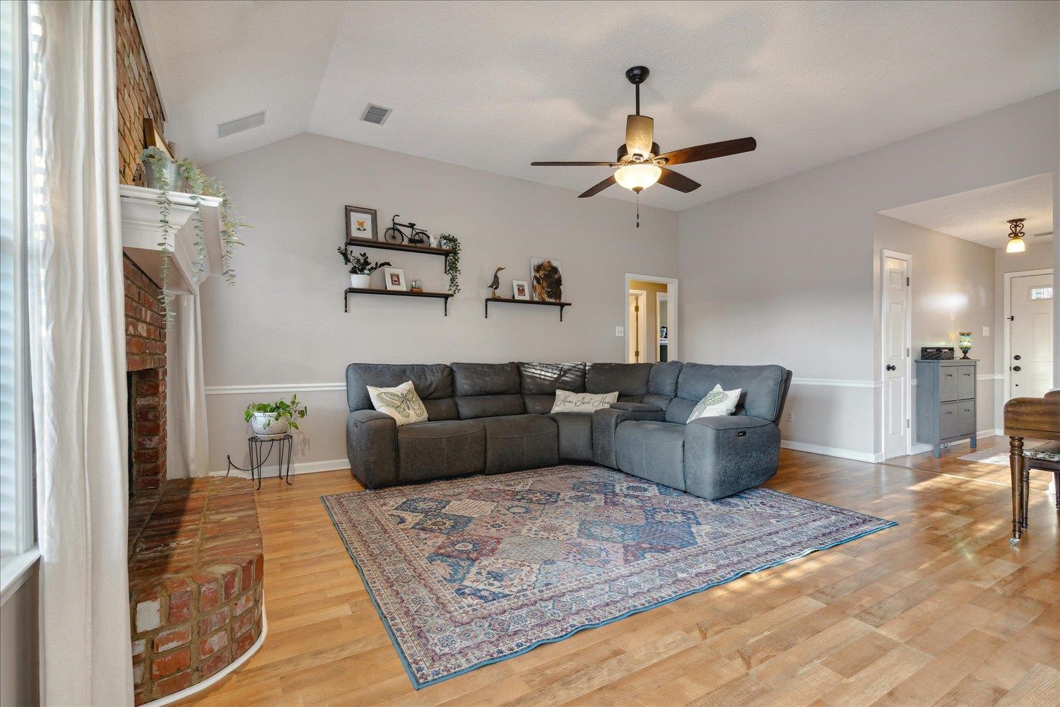 6893 Andrews Road Bartlett, TN 38135 - Photo 14 of 30 Living room with plenty of natural light, ceiling fan, light hardwood / wood-style flooring, and a brick fireplace