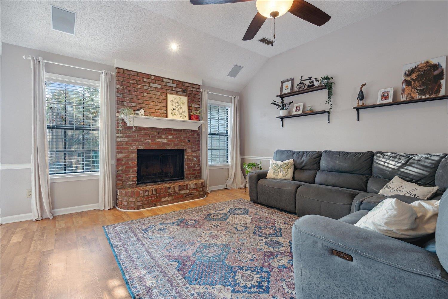 6893 Andrews Road Bartlett, TN 38135 - Photo 15 of 30 Living room featuring lofted ceiling, a fireplace, light wood-type flooring, and a wealth of natural light