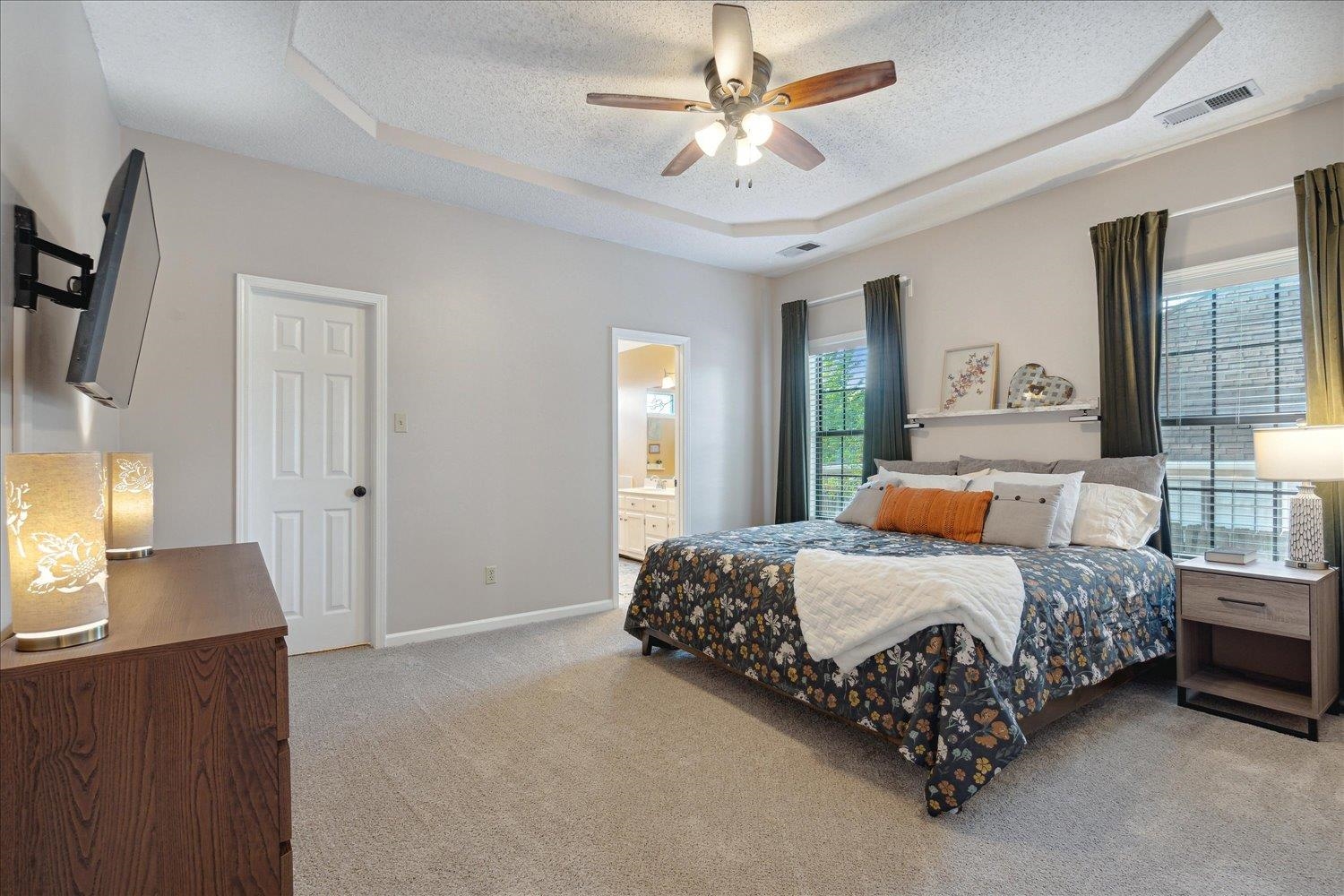 6893 Andrews Road Bartlett, TN 38135 - Photo 17 of 30 Bedroom with light carpet, a tray ceiling, ensuite bath, a textured ceiling, and ceiling fan