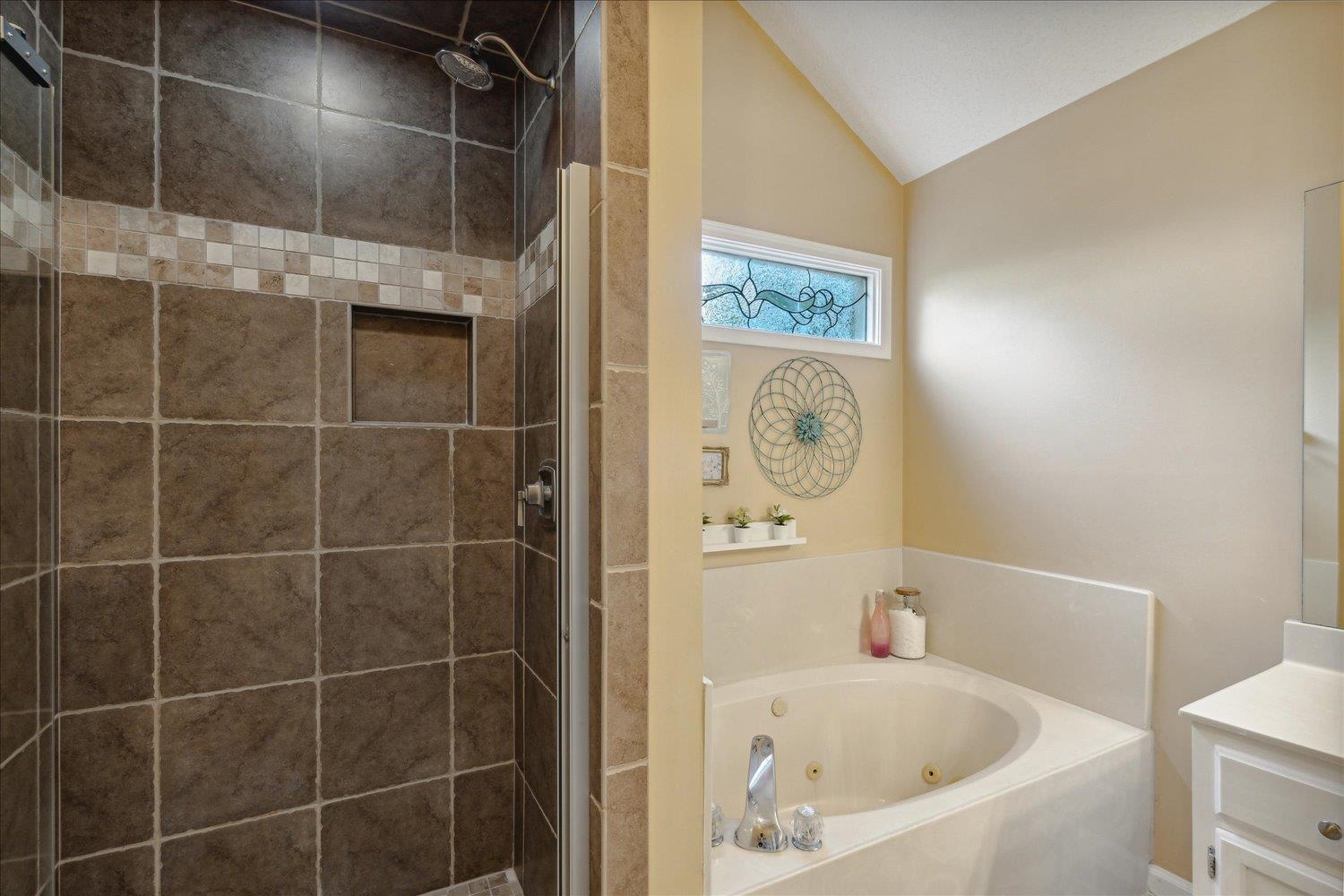 6893 Andrews Road Bartlett, TN 38135 - Photo 19 of 30 Bathroom with vanity, vaulted ceiling, and separate shower and tub