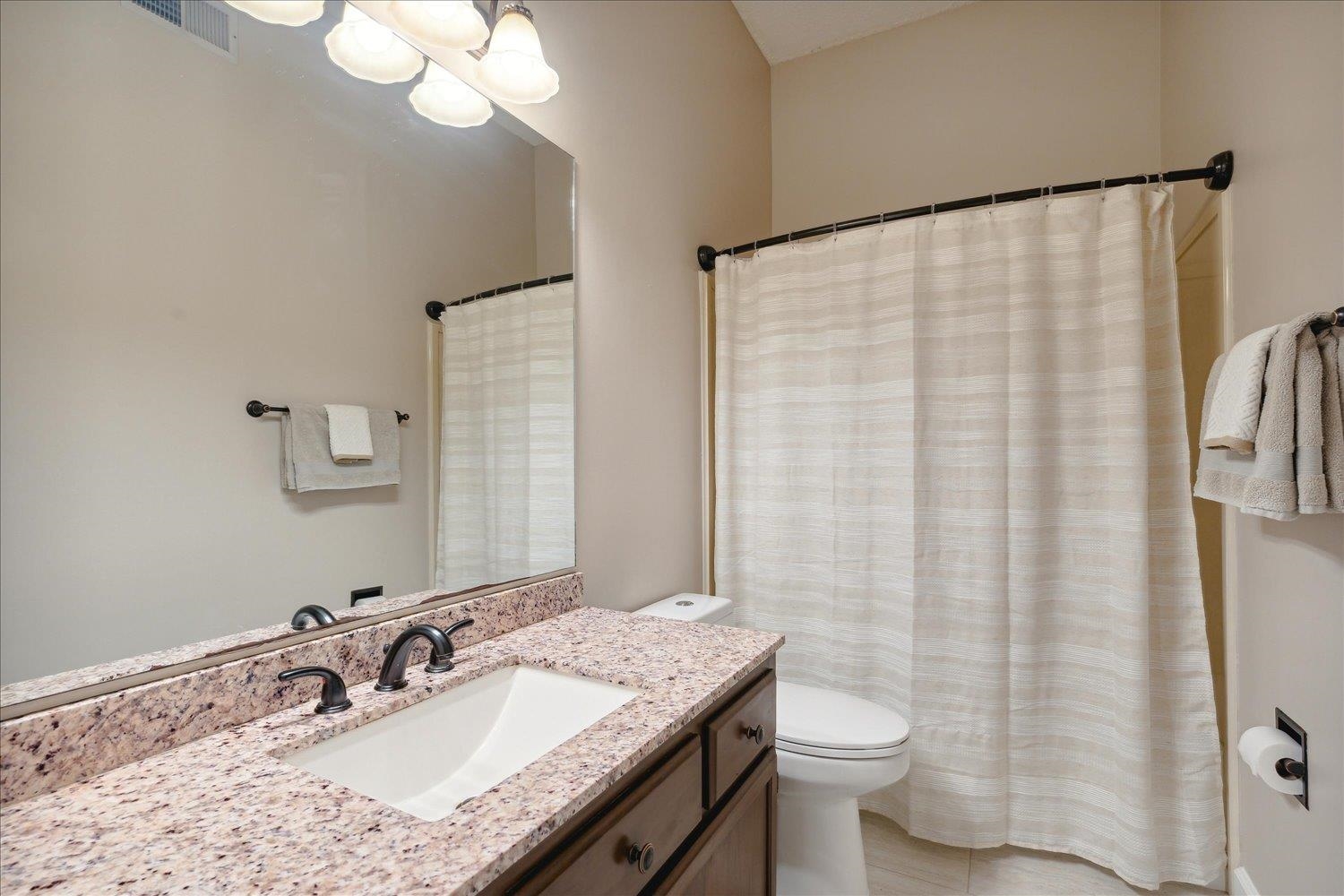6893 Andrews Road Bartlett, TN 38135 - Photo 23 of 30 Bathroom with toilet, walk in shower, vanity, and tile patterned flooring