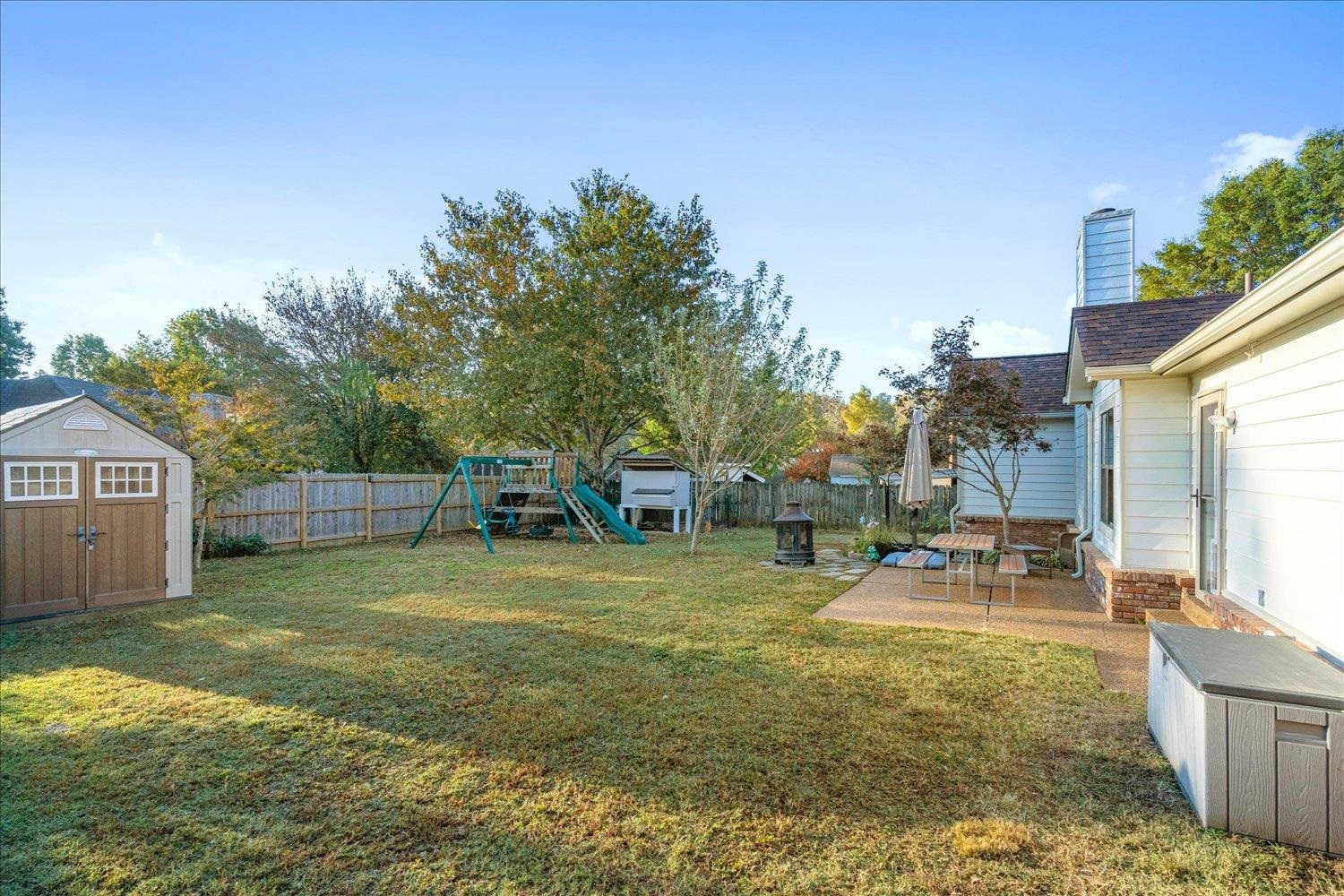 6893 Andrews Road Bartlett, TN 38135 - Photo 26 of 30 View of yard featuring a patio, a storage unit, and a playground