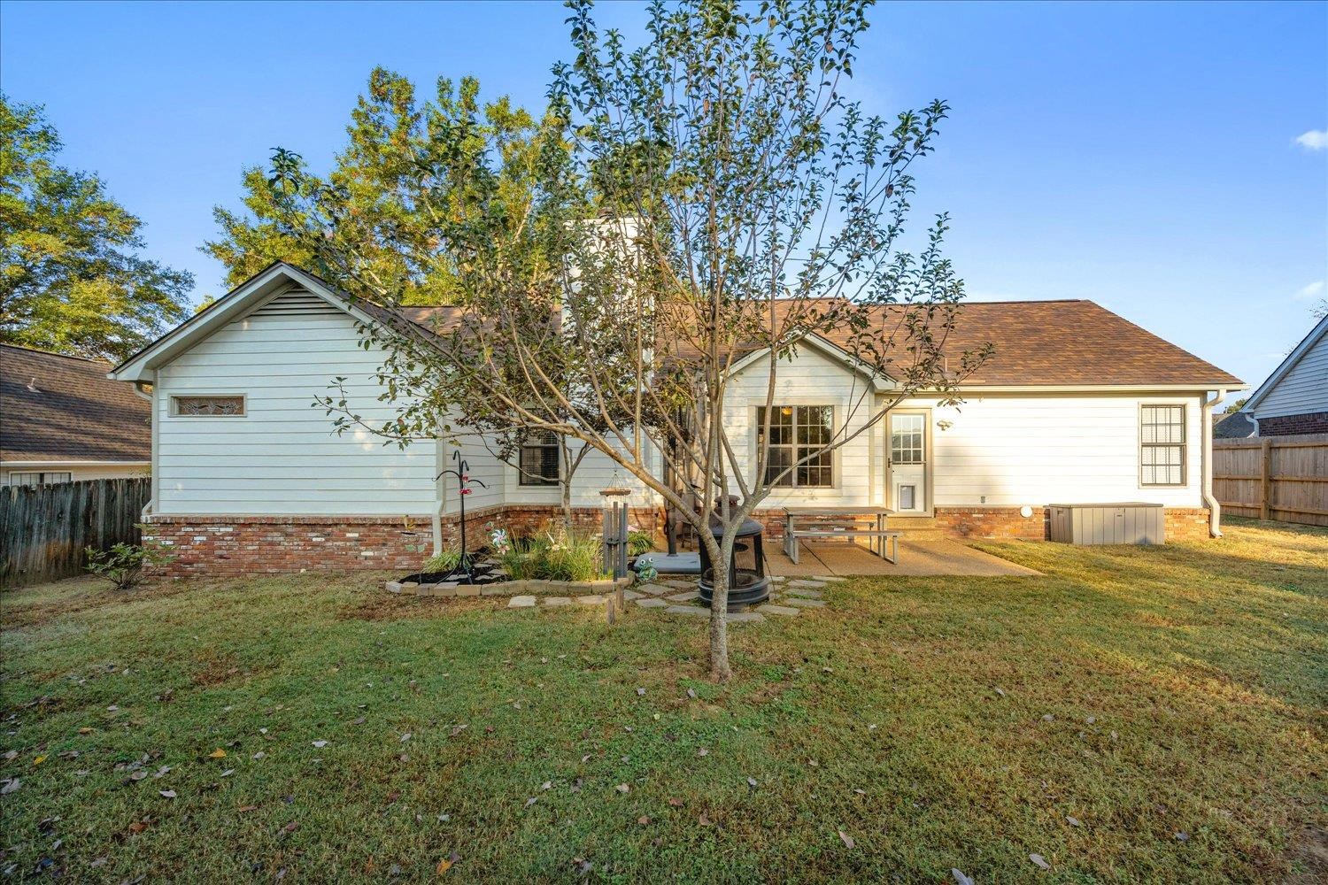 6893 Andrews Road Bartlett, TN 38135 - Photo 29 of 30 Rear view of house featuring a patio area and a lawn