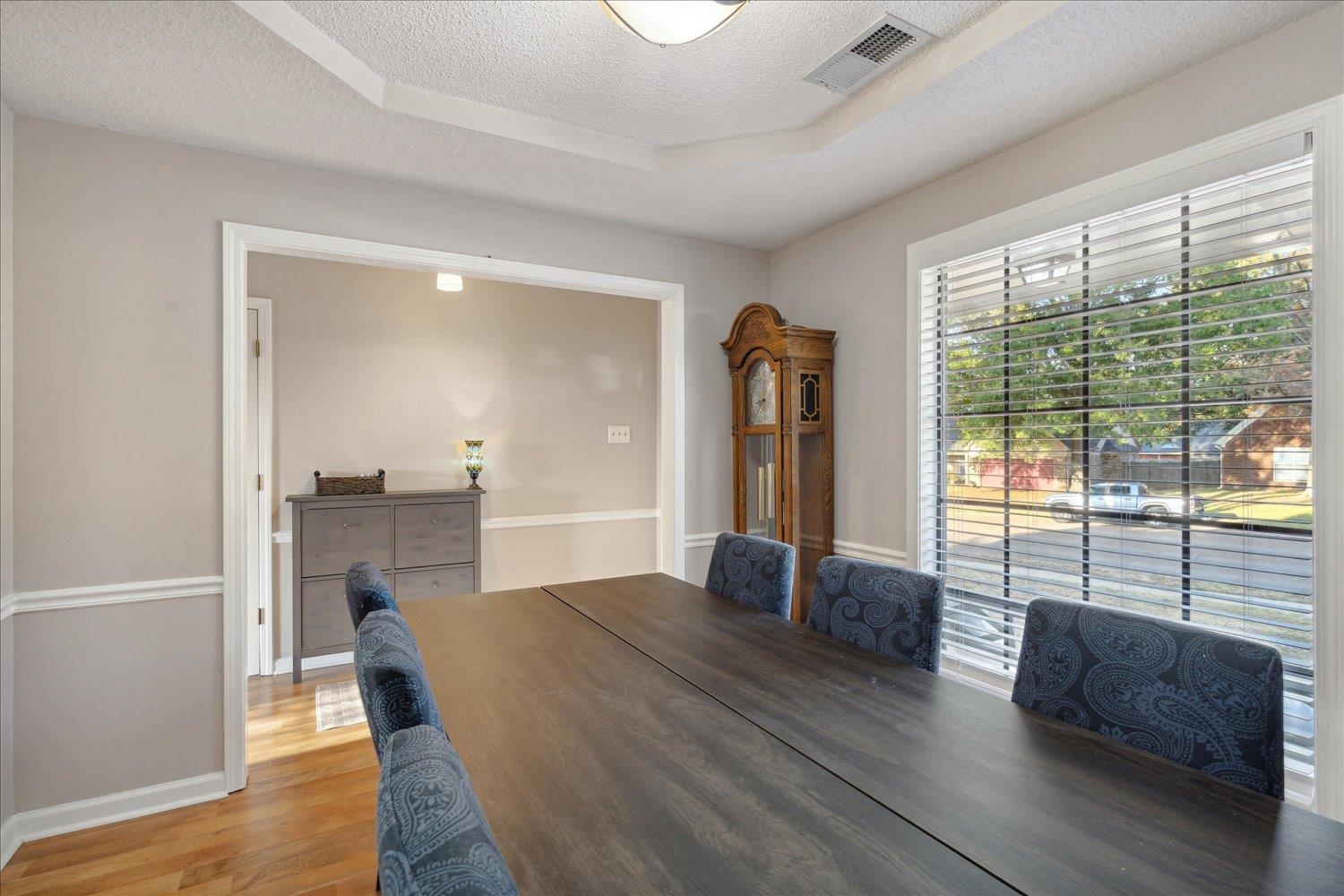 6893 Andrews Road Bartlett, TN 38135 - Photo 9 of 30 Dining room featuring a textured ceiling, hardwood / wood-style flooring, and a tray ceiling