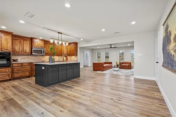 a kitchen with sink cabinets and wooden floor