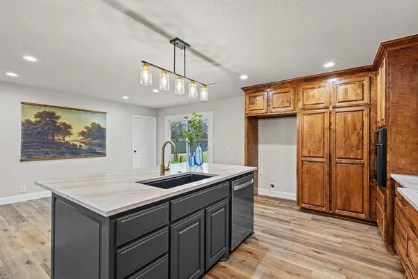 a kitchen with stainless steel appliances granite countertop a refrigerator and a sink